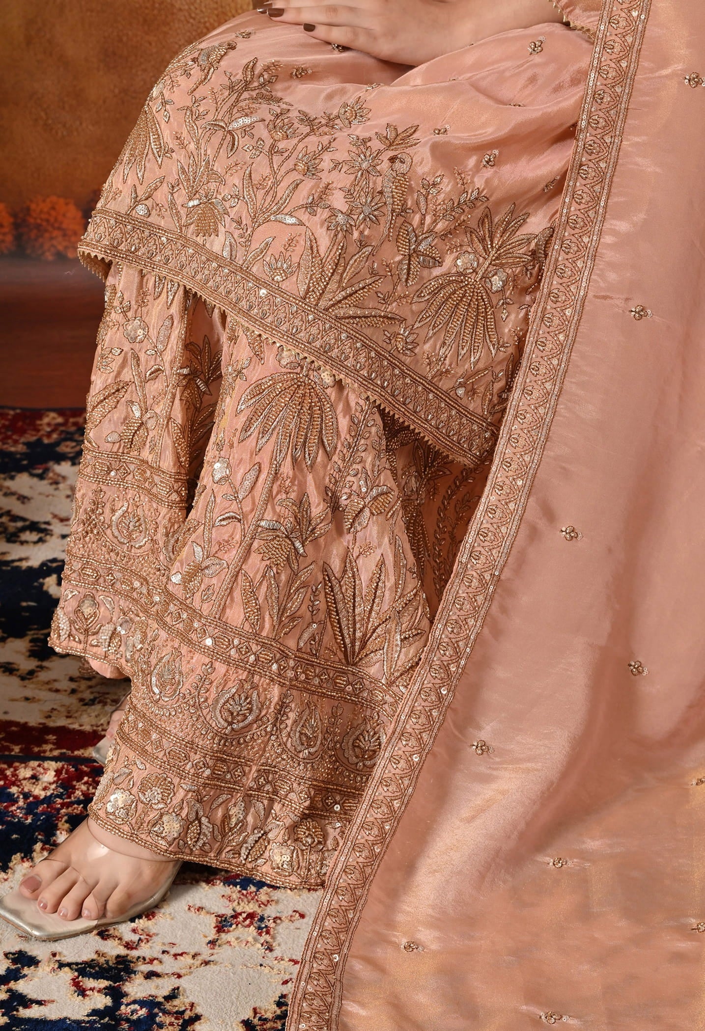 Peach Sharara Set with intricate zardozi, cutdana, crystal, and thread embroidery.