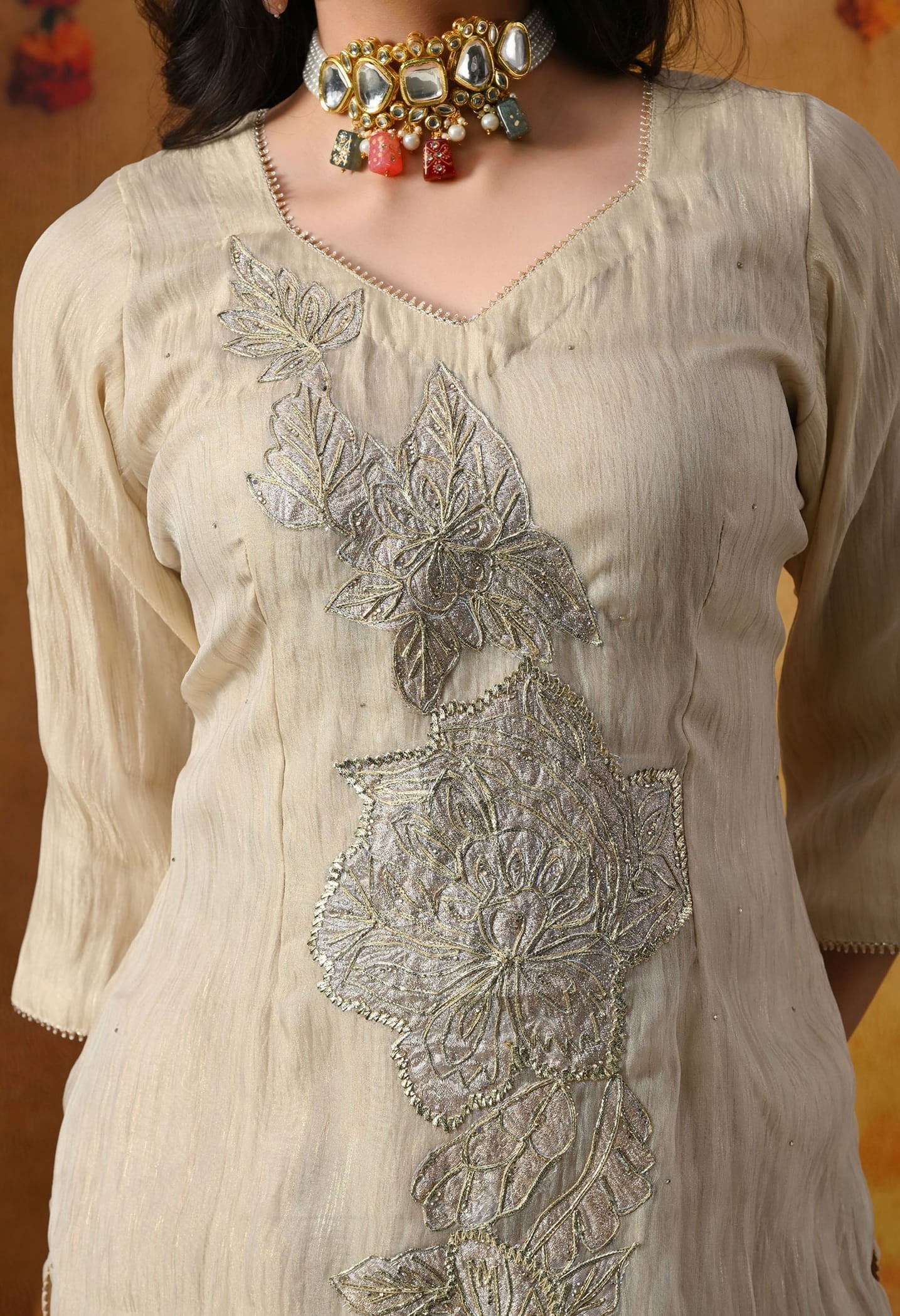Golden Sharara Set in crust tissue organza with intricate gotta, crystal, and applique work, paired with a golden brown sharara and dupatta