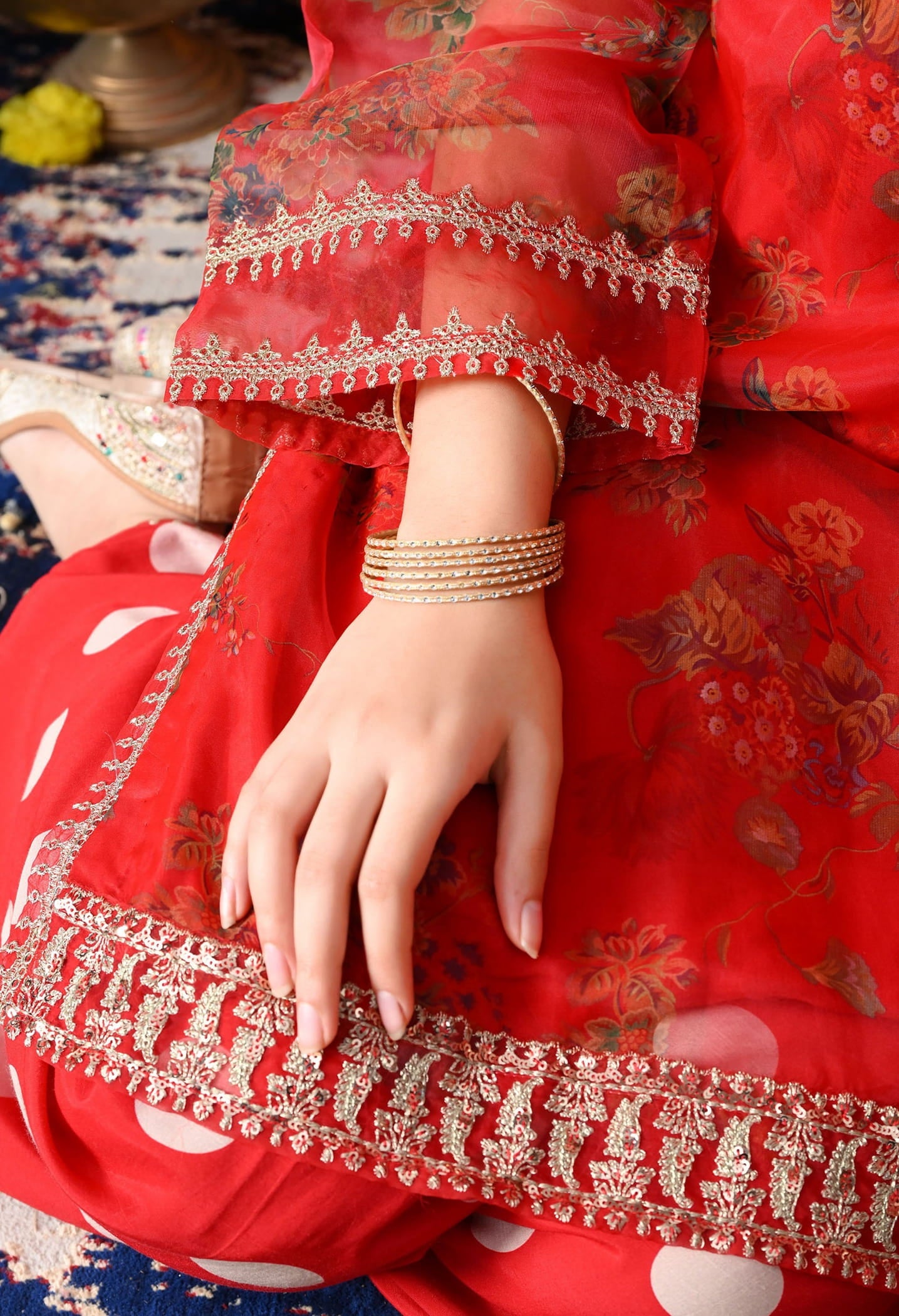 Elegant red kurta set in organza featuring intricate zardozi and sequin work, paired with a graceful farshi salwar and matching dupatta