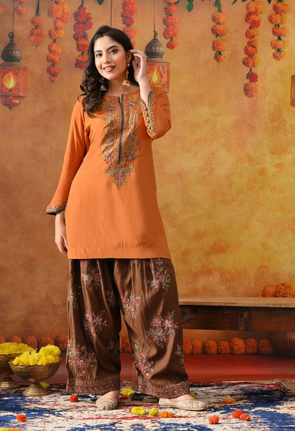 Orange Silk Kurta Set with intricate thread, sequin, and zardozi work, paired with a brown farshi salwar and net dupatta