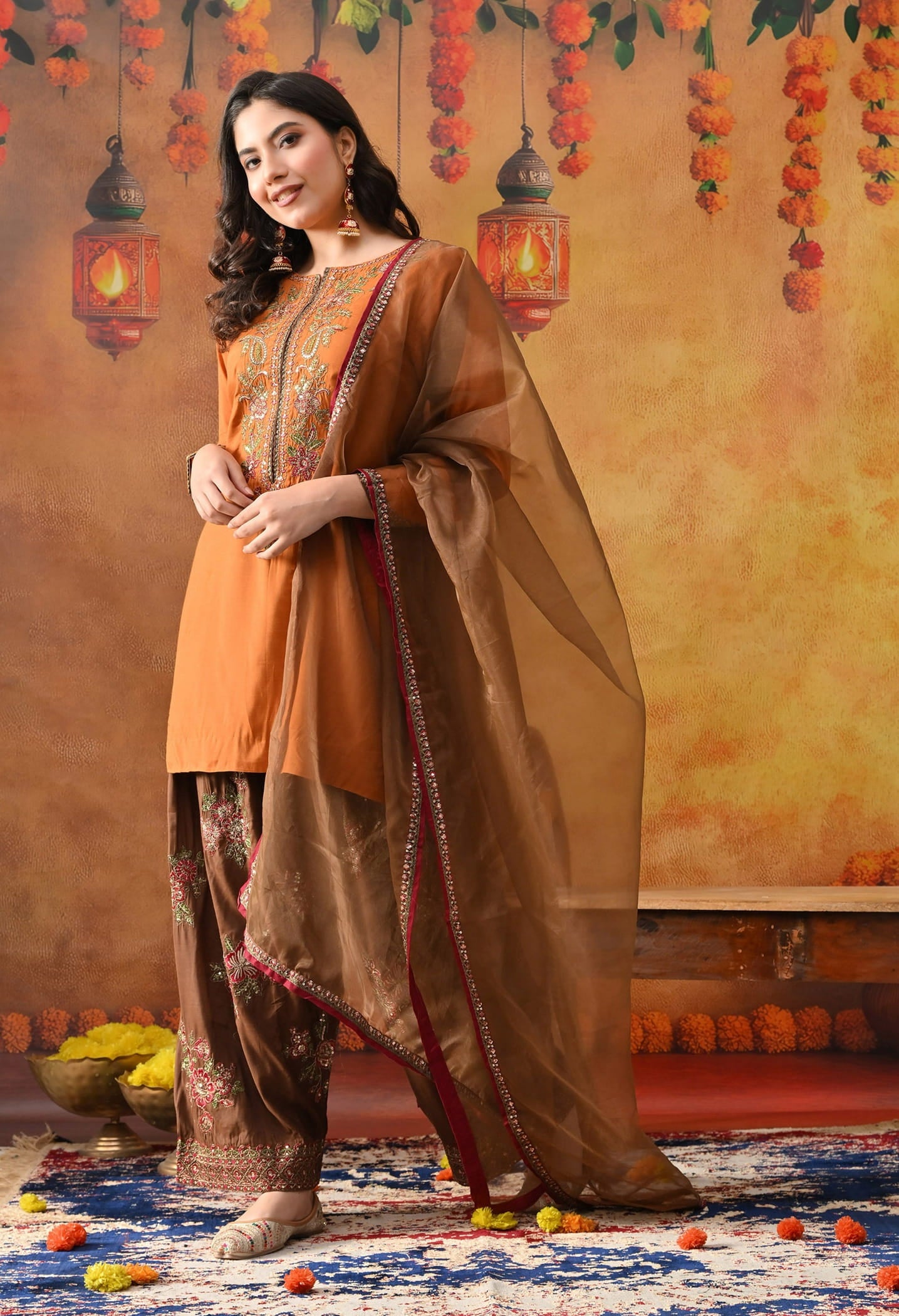Orange Silk Kurta Set with intricate thread, sequin, and zardozi work, paired with a brown farshi salwar and net dupatta
