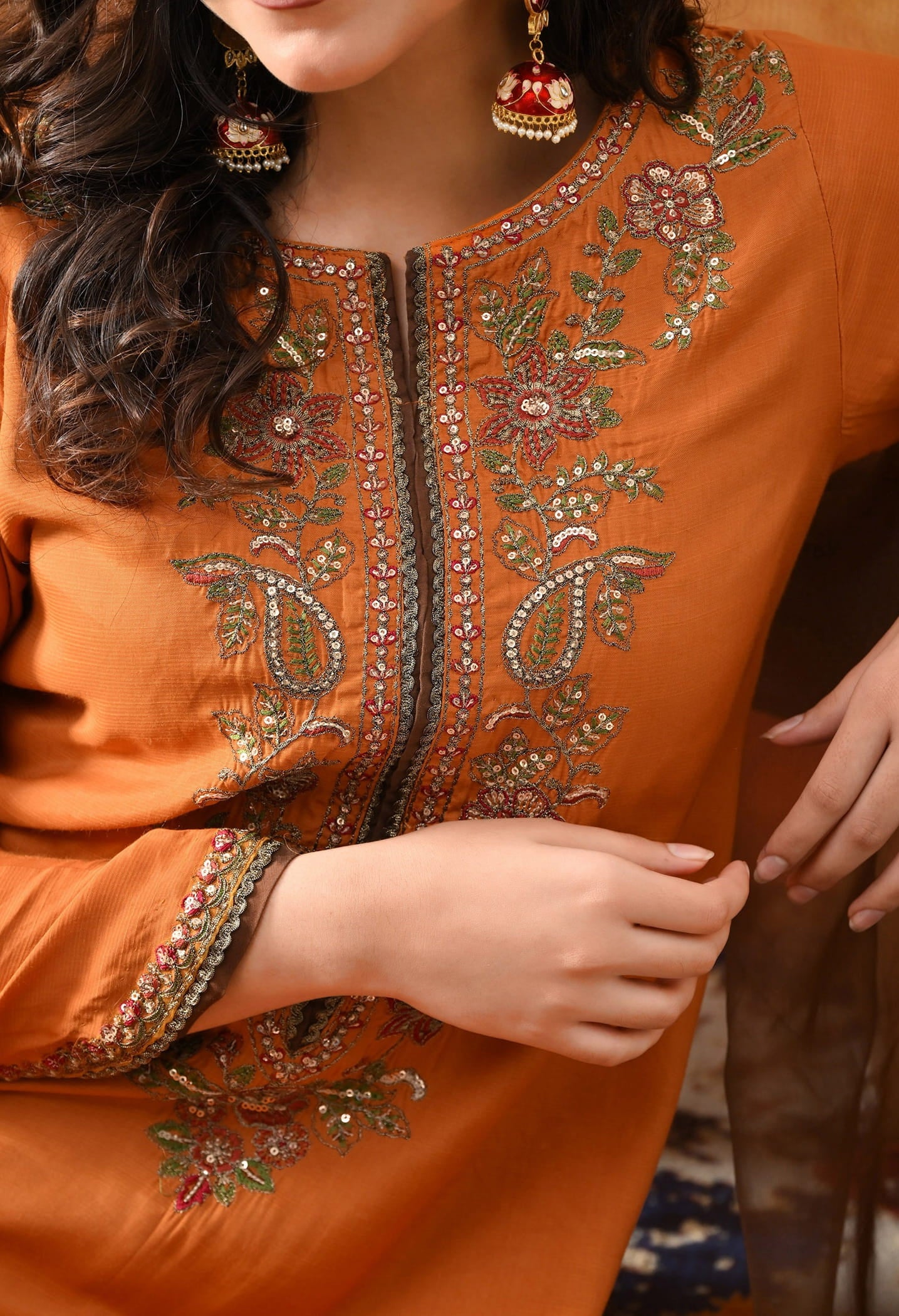 Orange Silk Kurta Set with intricate thread, sequin, and zardozi work, paired with a brown farshi salwar and net dupatta