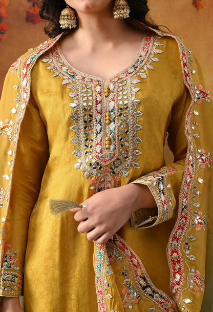Yellow Tissue Crepe Sharara Set with intricate gotta, zardozi, applique, thread, and mirror work, paired with a dual-tone yellow and green dupatta