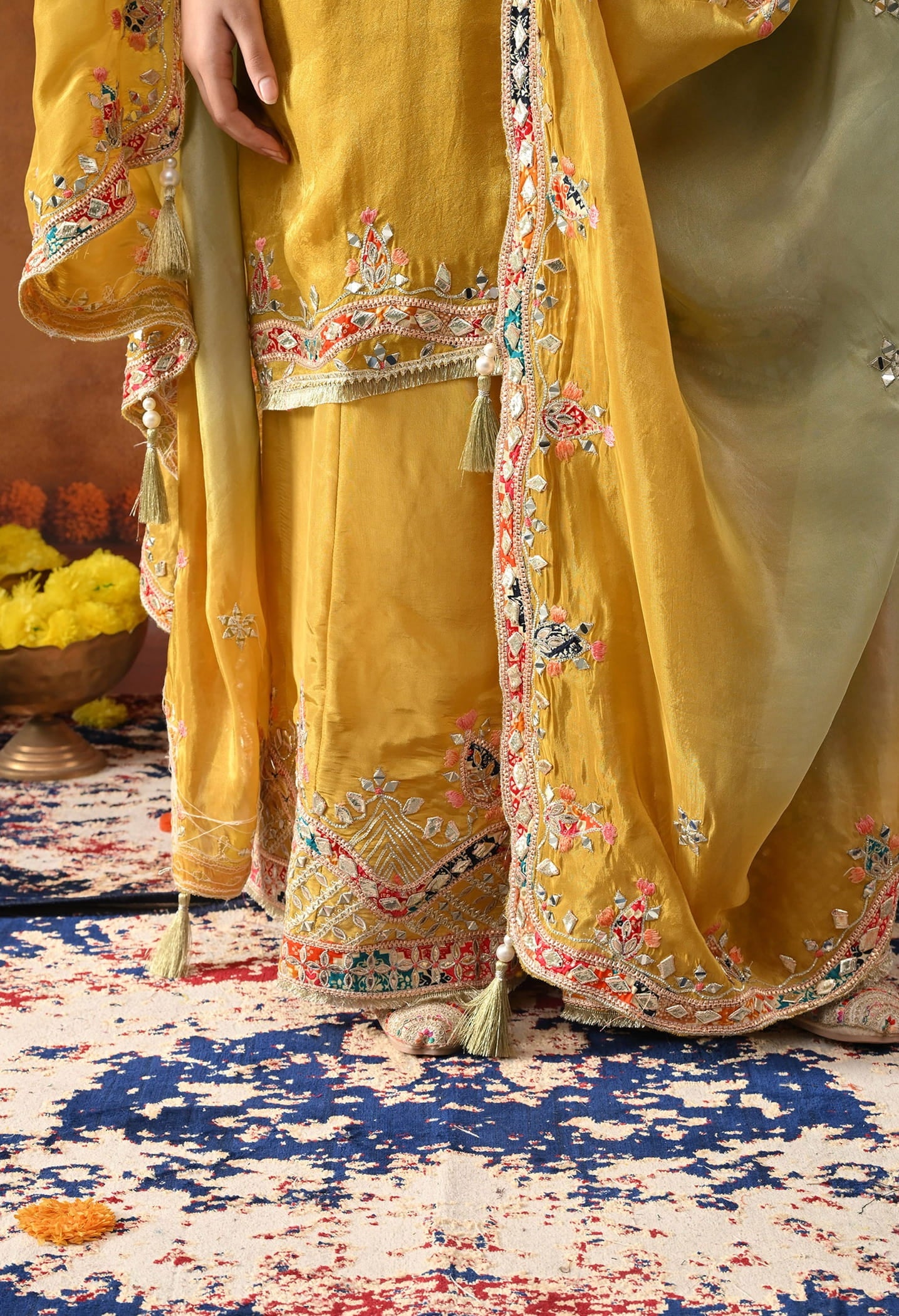 Yellow Tissue Crepe Sharara Set with intricate gotta, zardozi, applique, thread, and mirror work, paired with a dual-tone yellow and green dupatta