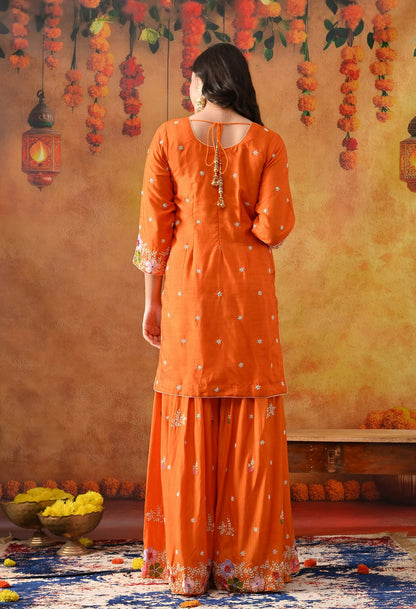 Orange Silk Gharara Set with intricate thread, pearl, and zardozi work, paired with an organza dupatta.