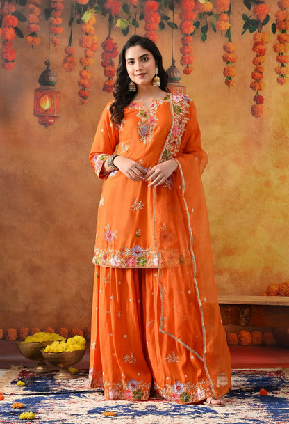 Orange Silk Gharara Set with intricate thread, pearl, and zardozi work, paired with an organza dupatta.