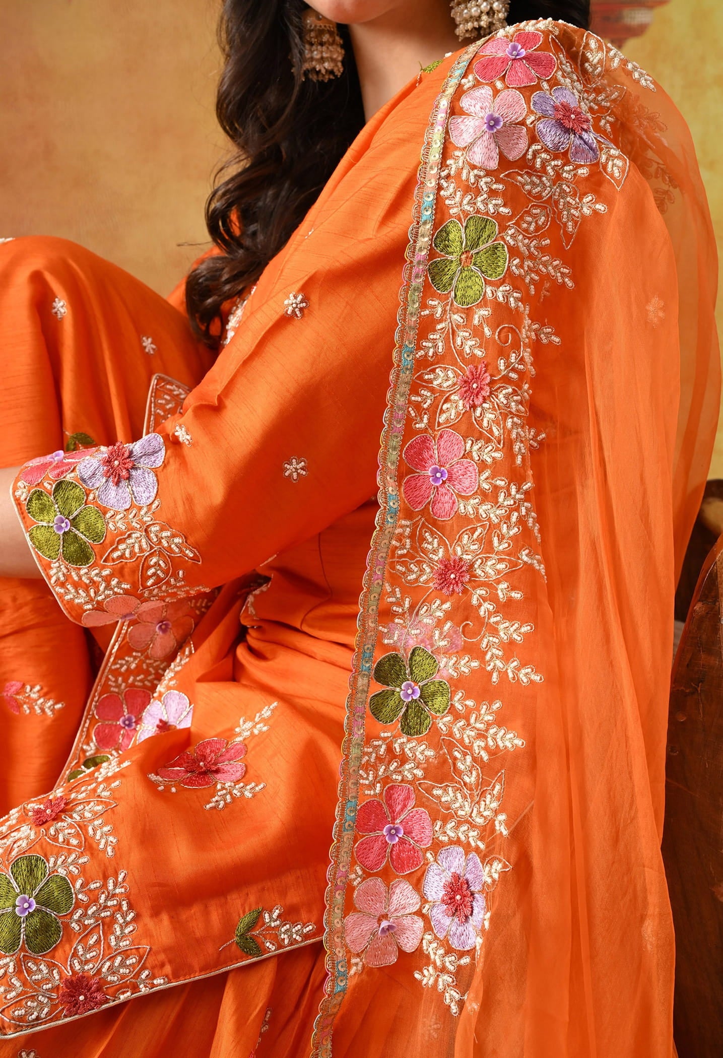 Orange Silk Gharara Set with intricate thread, pearl, and zardozi work, paired with an organza dupatta.