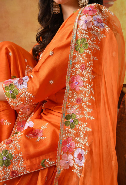 Orange Silk Gharara Set with intricate thread, pearl, and zardozi work, paired with an organza dupatta.