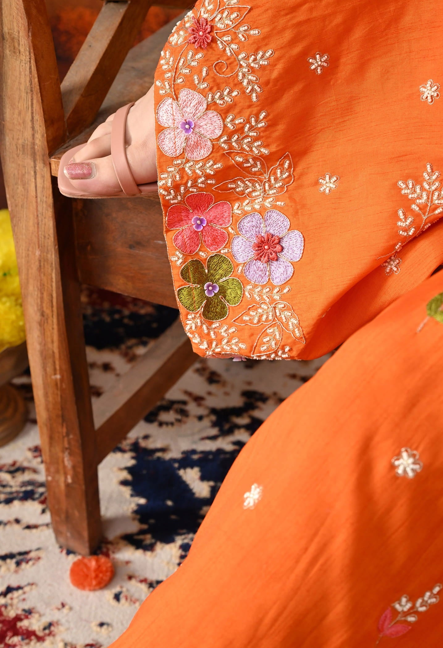 Orange Silk Gharara Set with intricate thread, pearl, and zardozi work, paired with an organza dupatta.