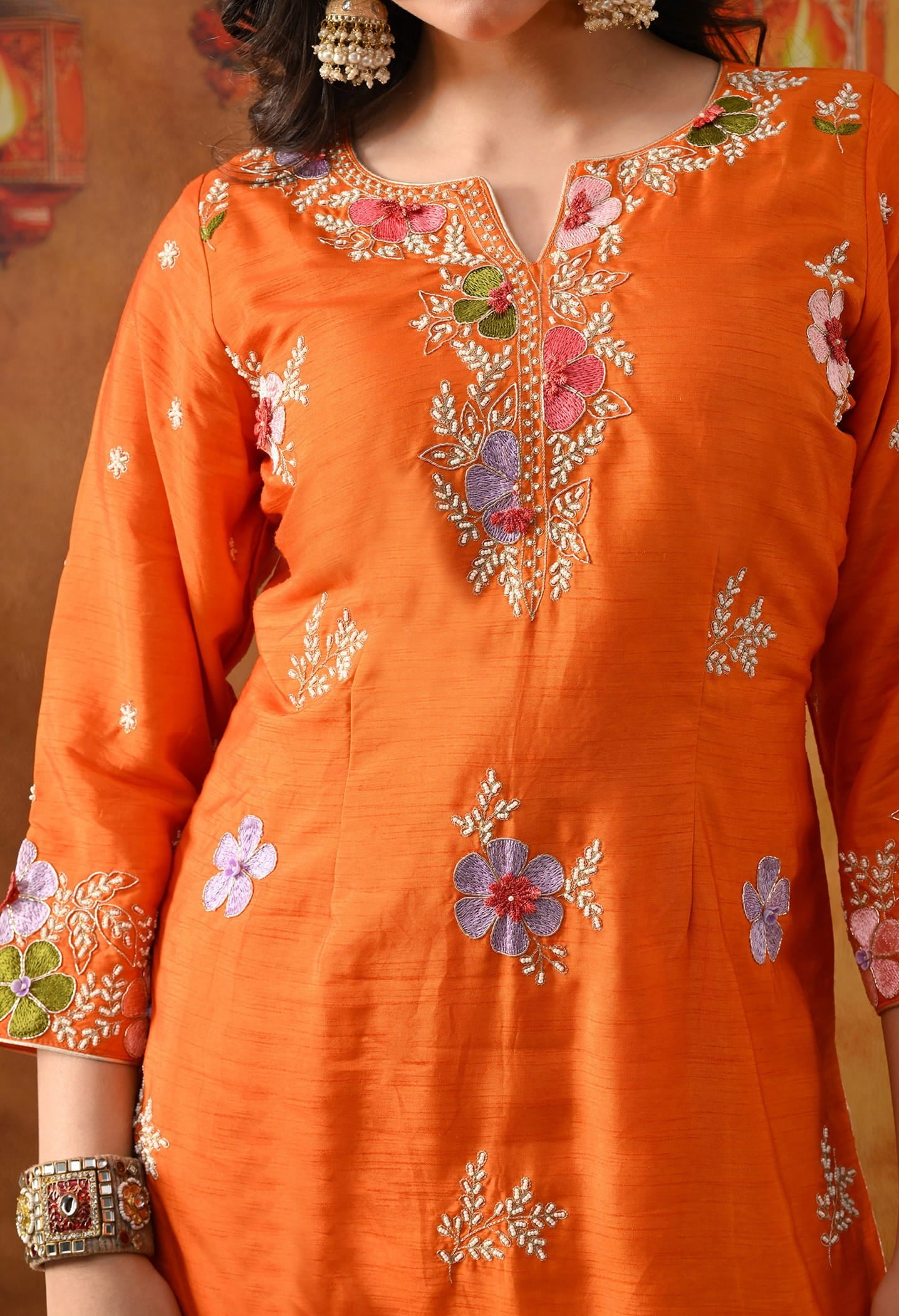 Orange Silk Gharara Set with intricate thread, pearl, and zardozi work, paired with an organza dupatta.