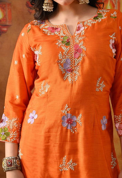 Orange Silk Gharara Set with intricate thread, pearl, and zardozi work, paired with an organza dupatta.
