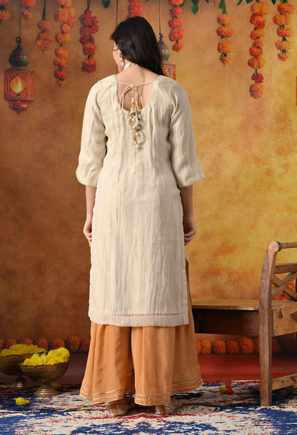 Golden Sharara Set in crust tissue organza with intricate gotta, crystal, and applique work, paired with a golden brown sharara and dupatta