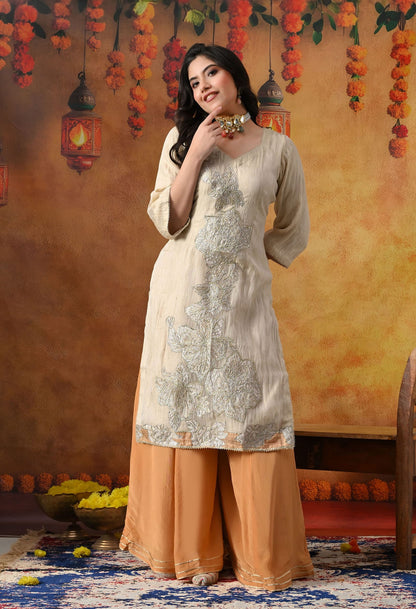 Golden Sharara Set in crust tissue organza with intricate gotta, crystal, and applique work, paired with a golden brown sharara and dupatta