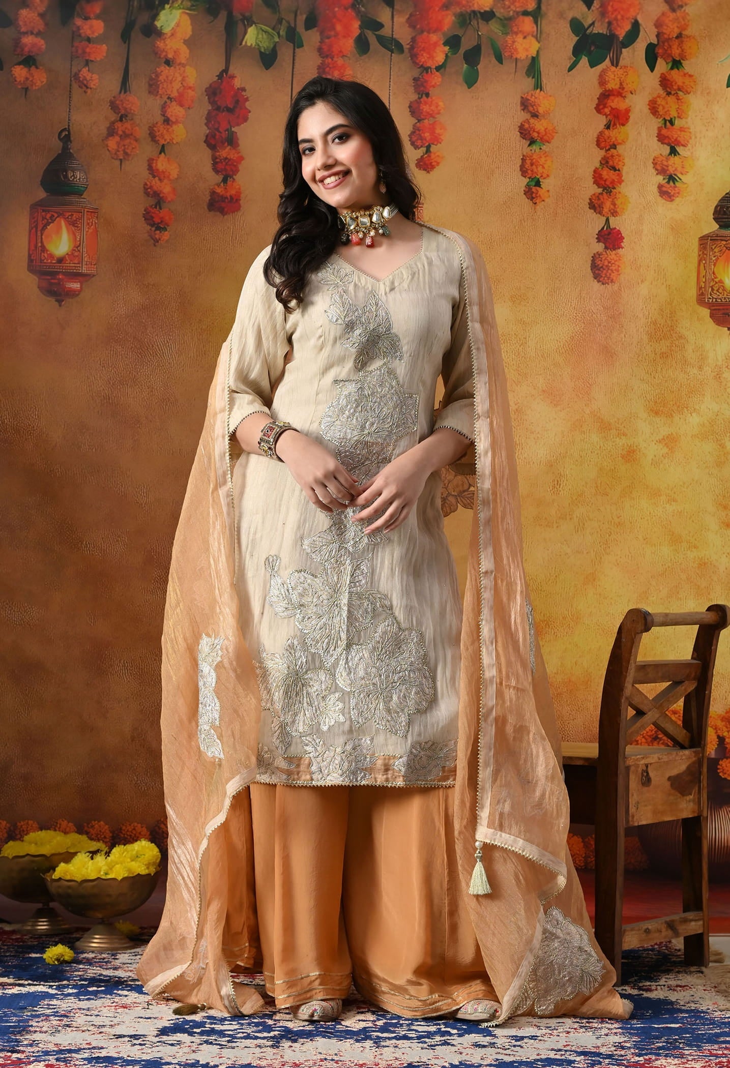 Golden Sharara Set in crust tissue organza with intricate gotta, crystal, and applique work, paired with a golden brown sharara and dupatta