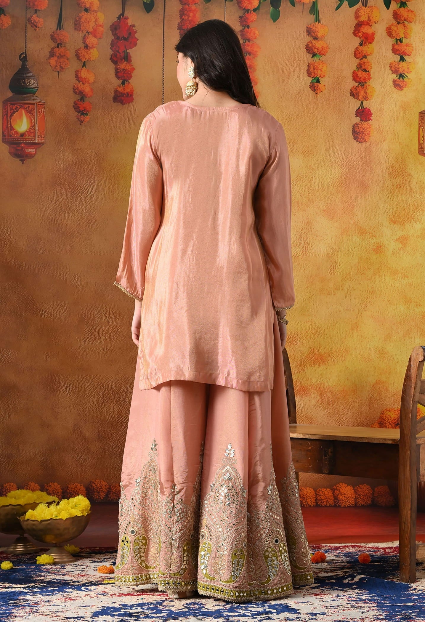 Peach Tissue Crepe Sharara Set with intricate gotta, zardozi, applique, and mirror work, paired with a contrasting green Banarasi silk dupatta