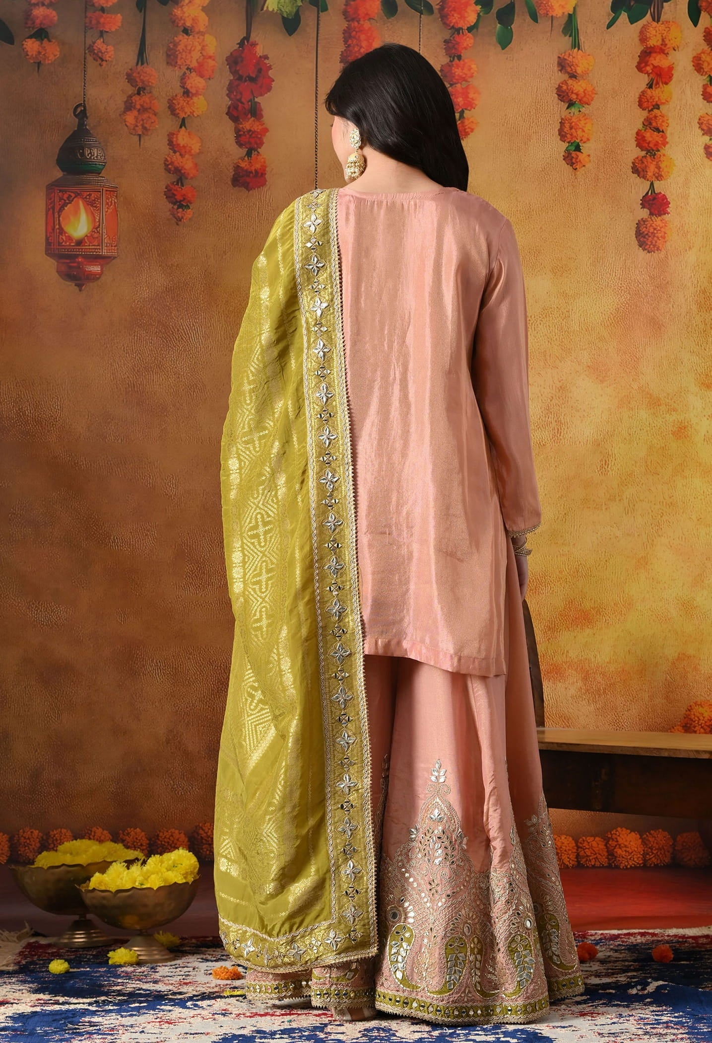 Peach Tissue Crepe Sharara Set with intricate gotta, zardozi, applique, and mirror work, paired with a contrasting green Banarasi silk dupatta