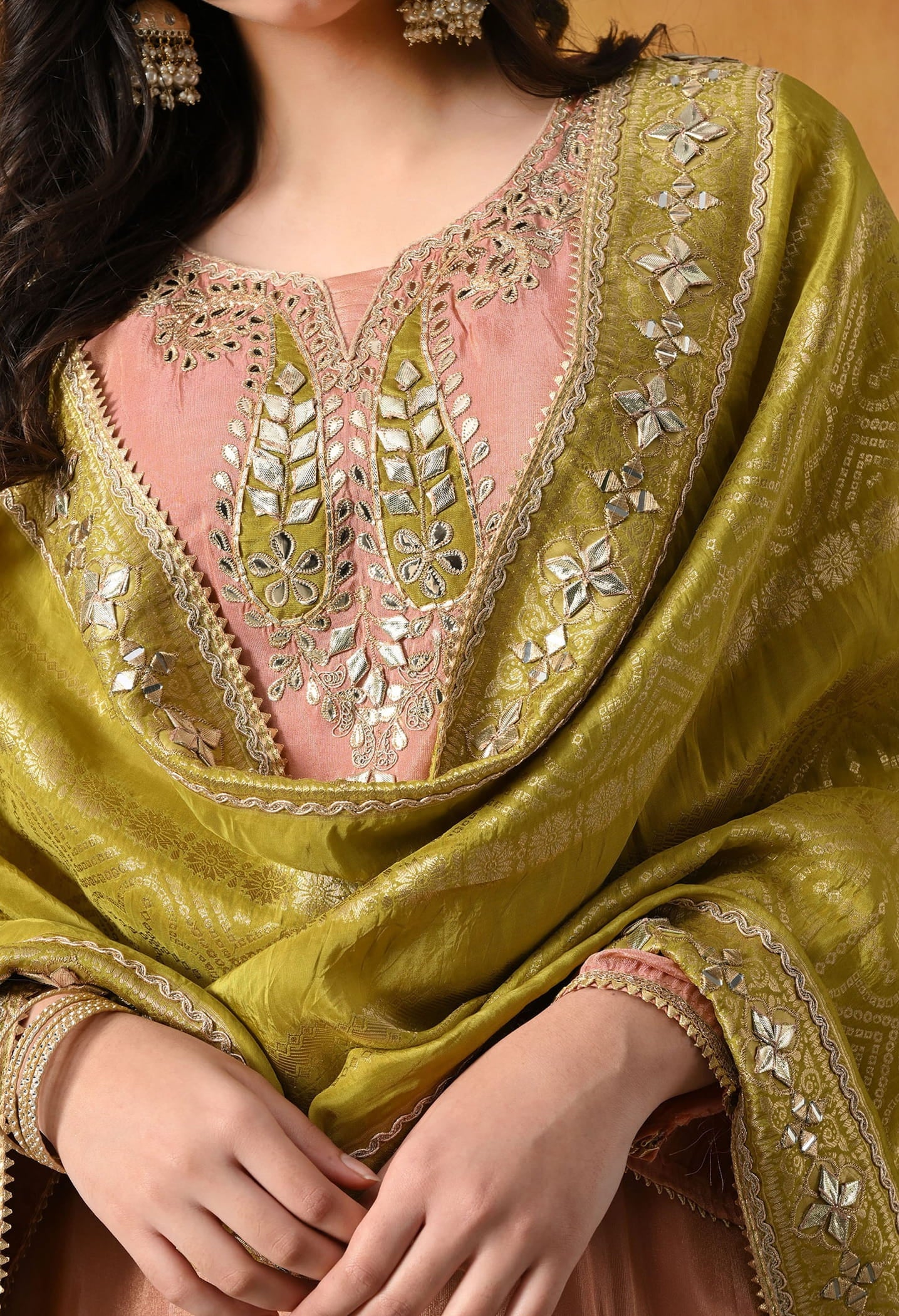 Peach Tissue Crepe Sharara Set with intricate gotta, zardozi, applique, and mirror work, paired with a contrasting green Banarasi silk dupatta