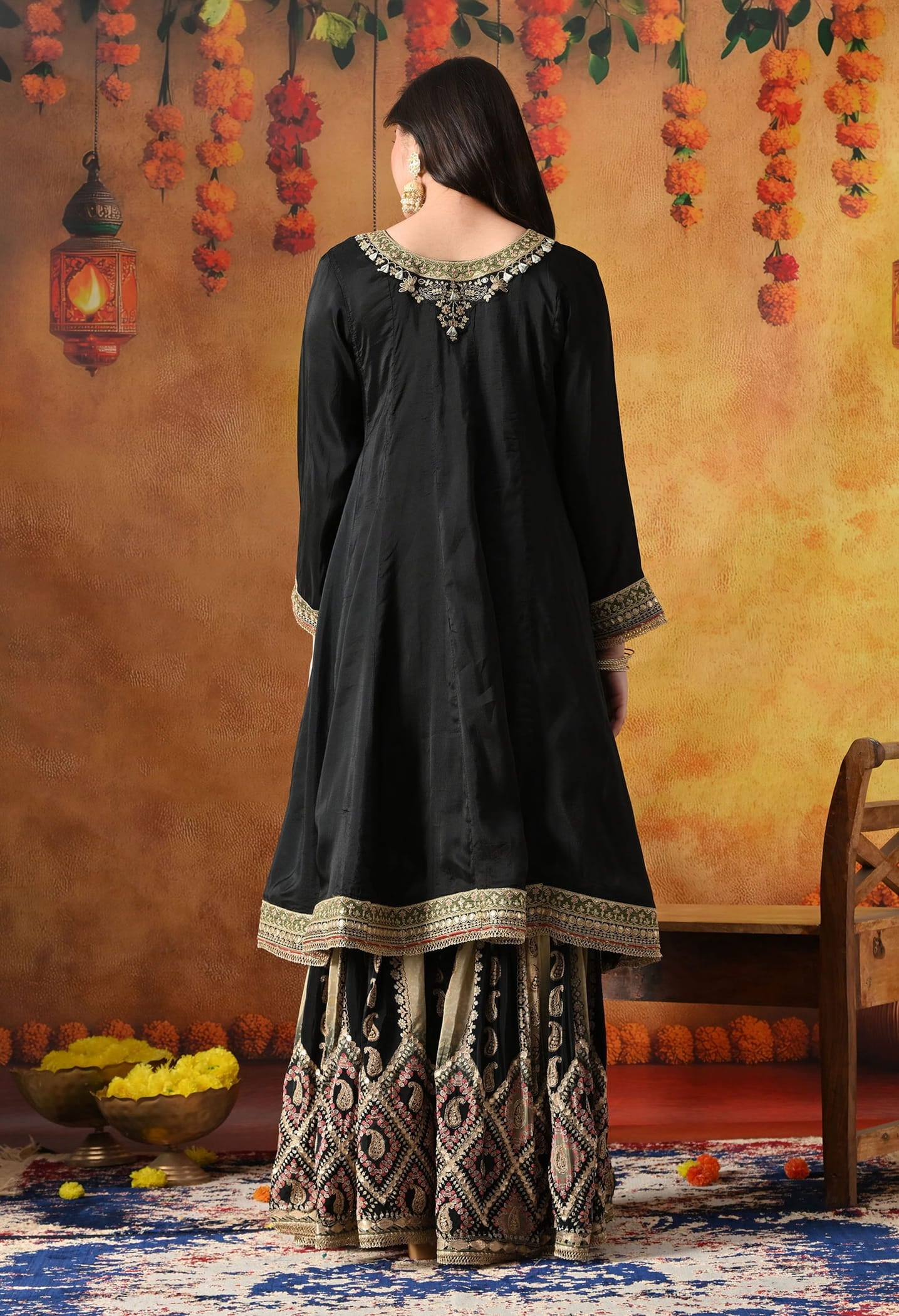 Elegant black gharara set in crepe with gotta, zardozi, and sequin work, paired with a printed gharara and dupatta