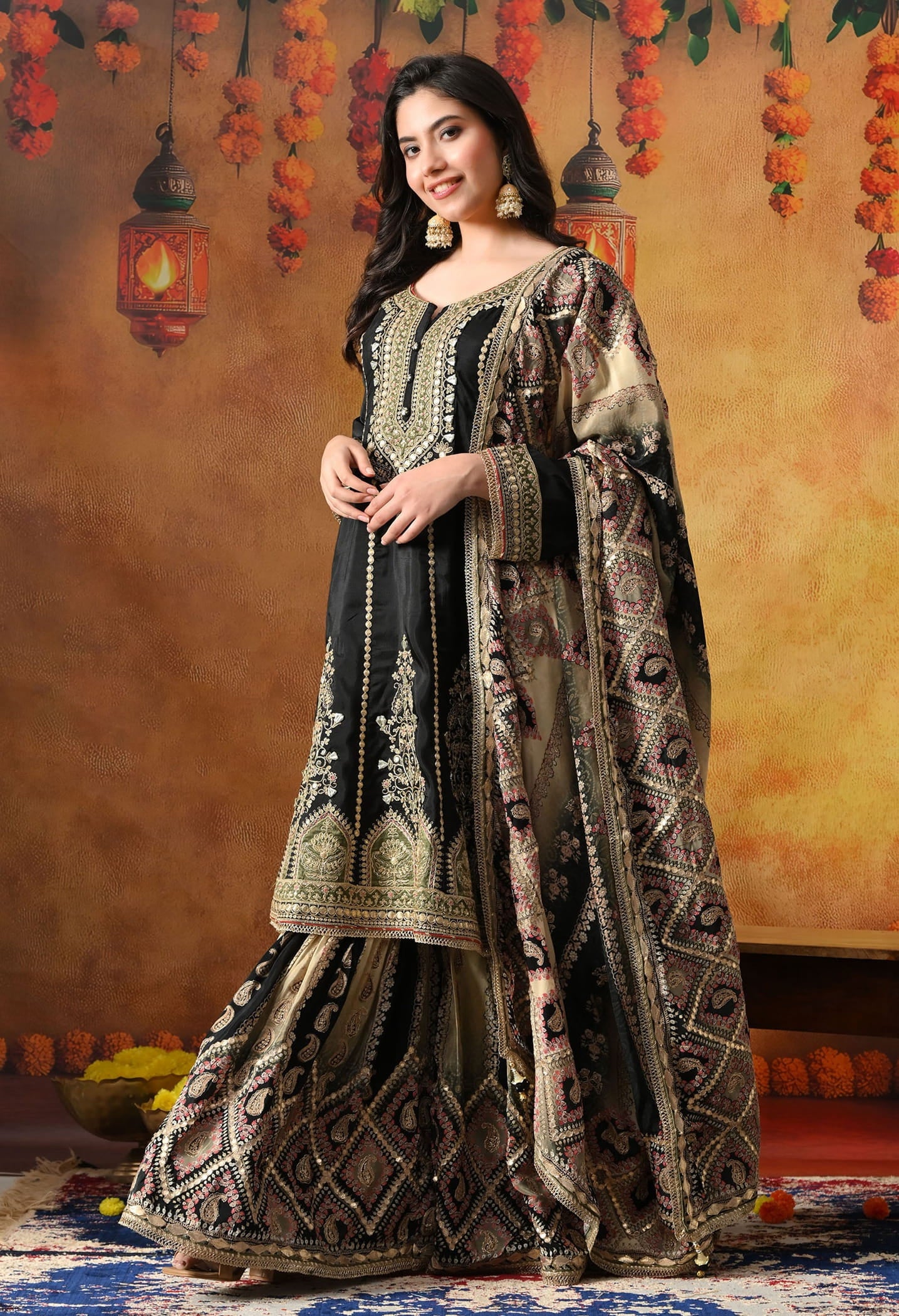 Elegant black gharara set in crepe with gotta, zardozi, and sequin work, paired with a printed gharara and dupatta