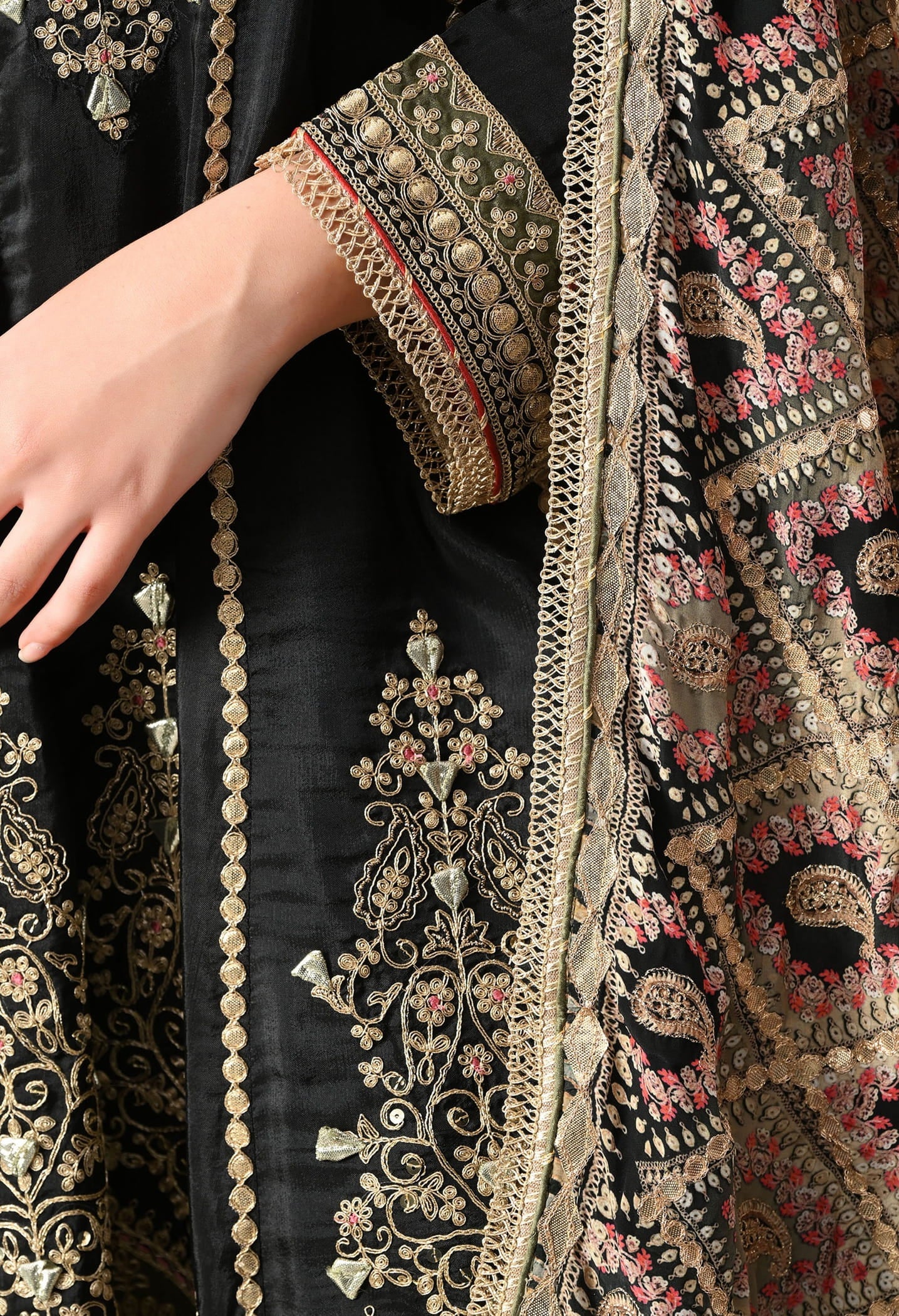 Elegant black gharara set in crepe with gotta, zardozi, and sequin work, paired with a printed gharara and dupatta