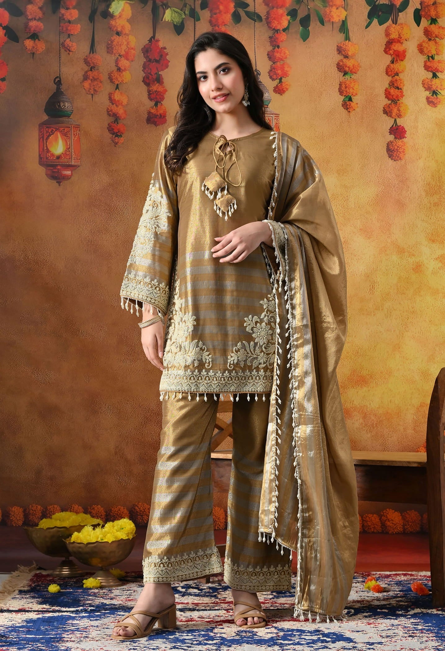 Elegant golden kurta set in tissue silk with thread and pearl work, paired with straight pants and matching dupatta