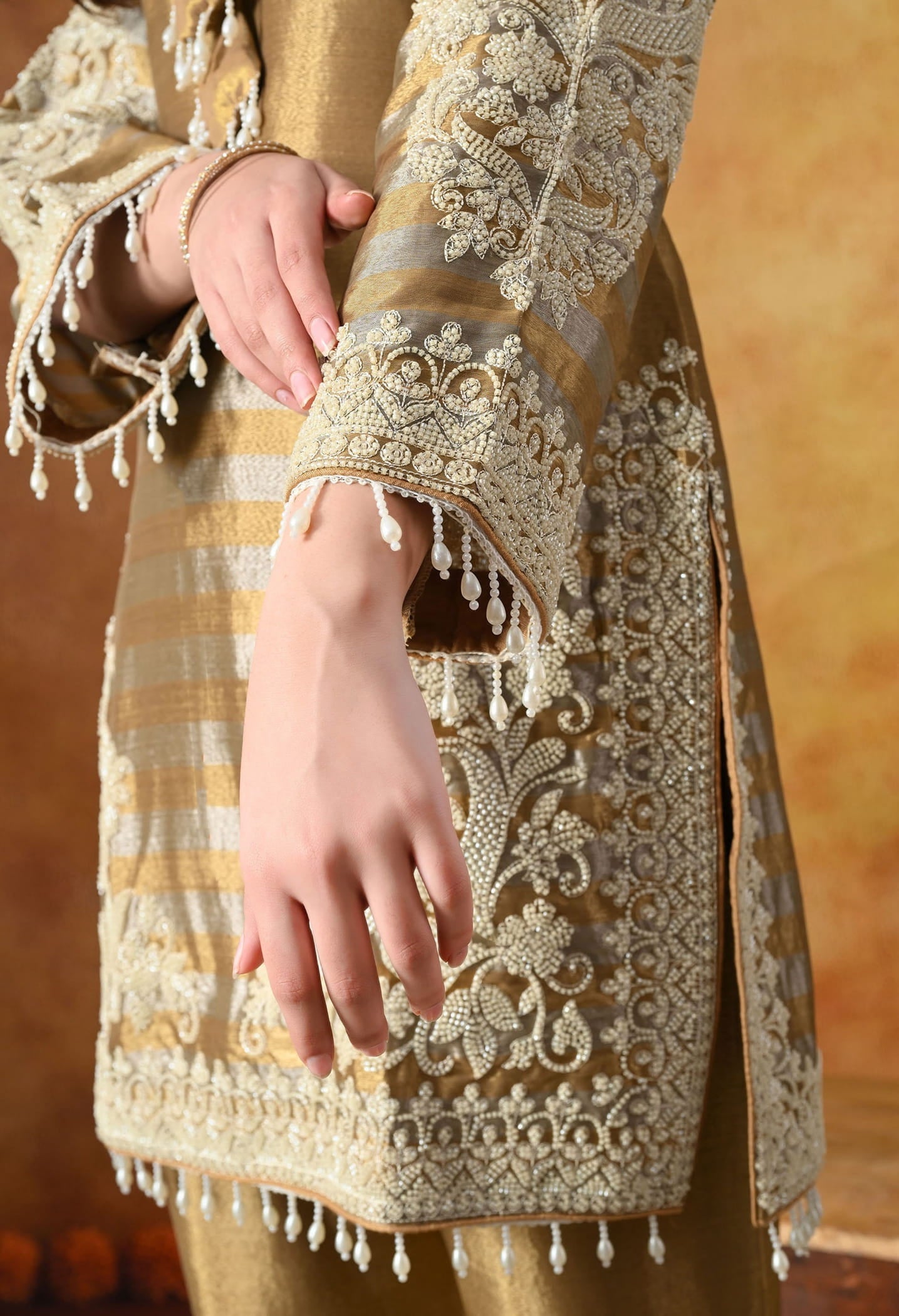 Elegant golden kurta set in tissue silk with thread and pearl work, paired with straight pants and matching dupatta