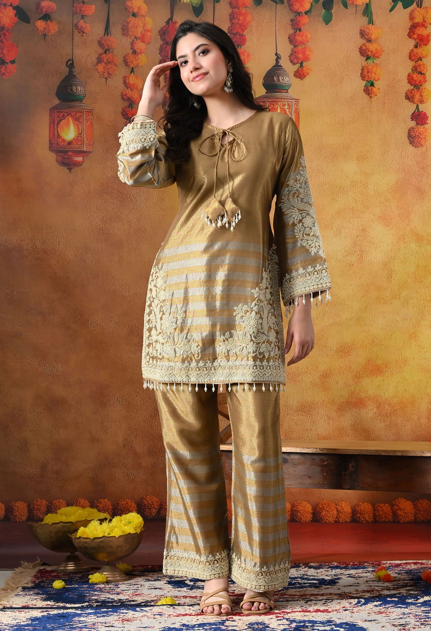 Elegant golden kurta set in tissue silk with thread and pearl work, paired with straight pants and matching dupatta