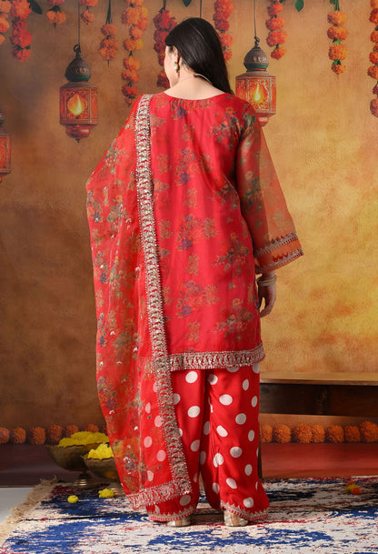 Elegant red kurta set in organza featuring intricate zardozi and sequin work, paired with a graceful farshi salwar and matching dupatta