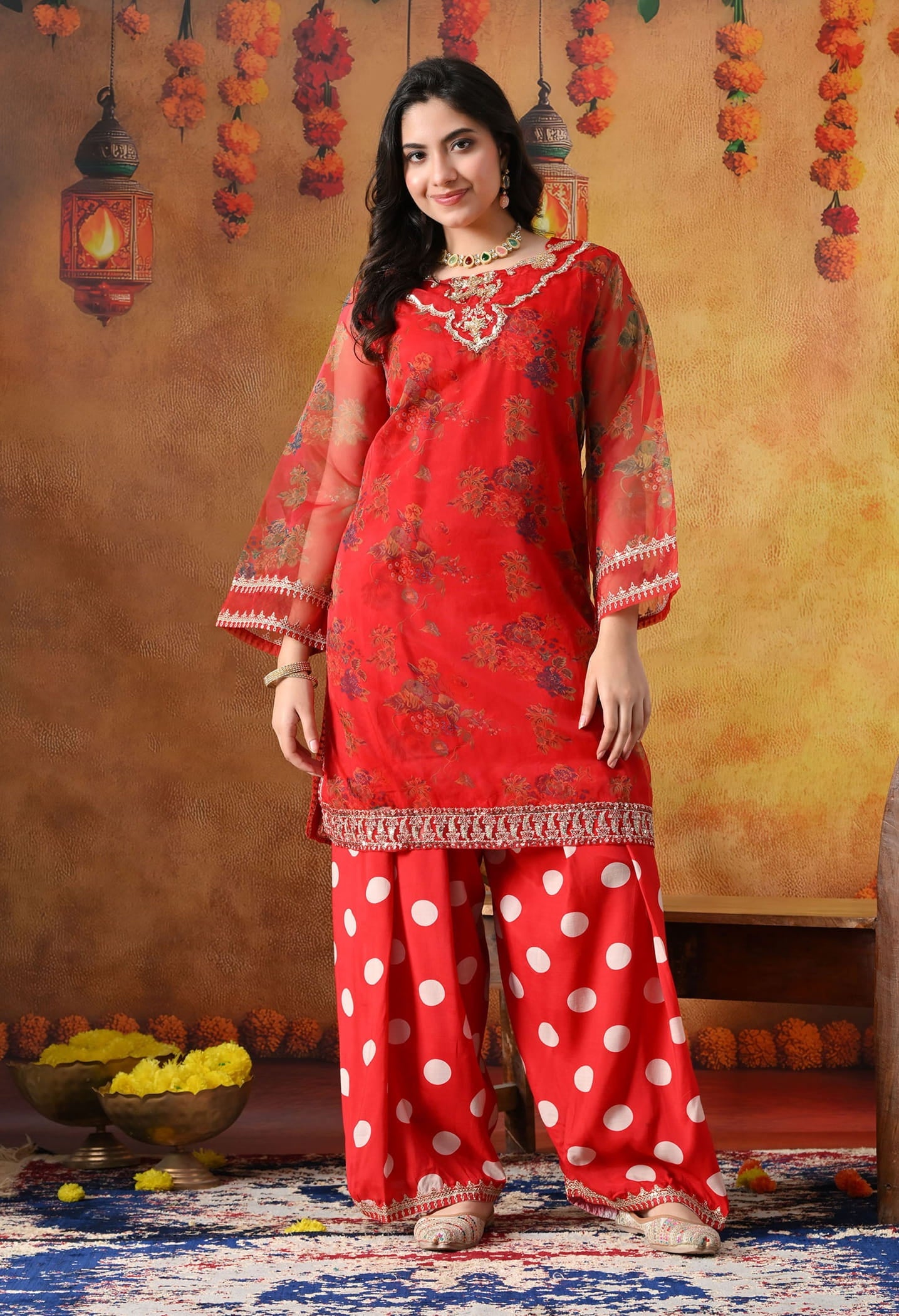 Elegant red kurta set in organza featuring intricate zardozi and sequin work, paired with a graceful farshi salwar and matching dupatta