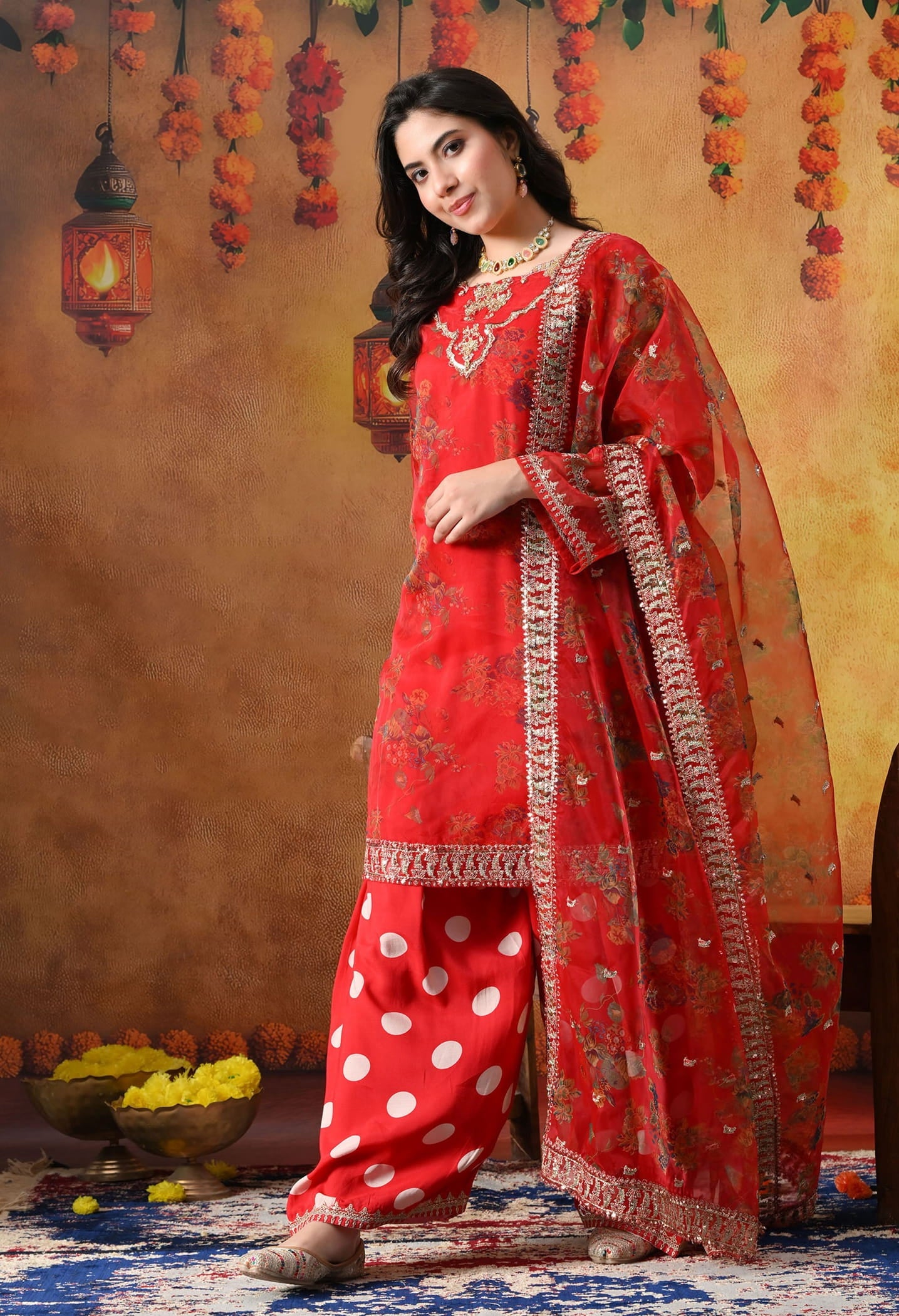 Elegant red kurta set in organza featuring intricate zardozi and sequin work, paired with a graceful farshi salwar and matching dupatta