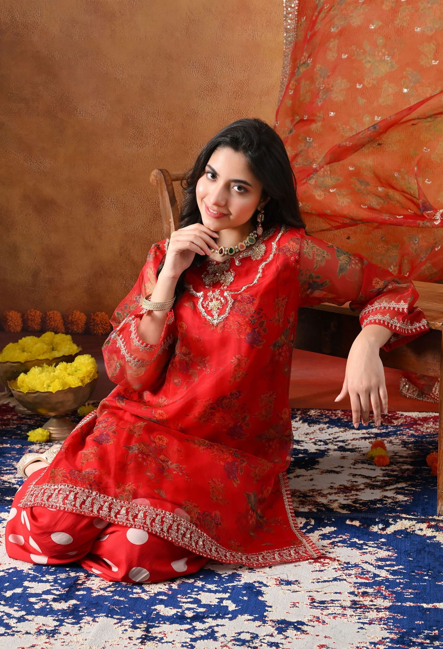 Elegant red kurta set in organza featuring intricate zardozi and sequin work, paired with a graceful farshi salwar and matching dupatta