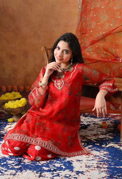 Elegant red kurta set in organza featuring intricate zardozi and sequin work, paired with a graceful farshi salwar and matching dupatta