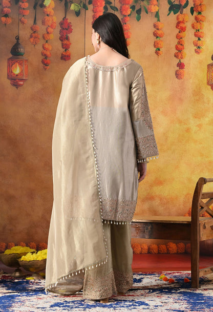 Golden Tissue Silk Kurta Set with intricate thread, pearl, and cutdana work, paired with a tissue organza dupatta and umbrella pants