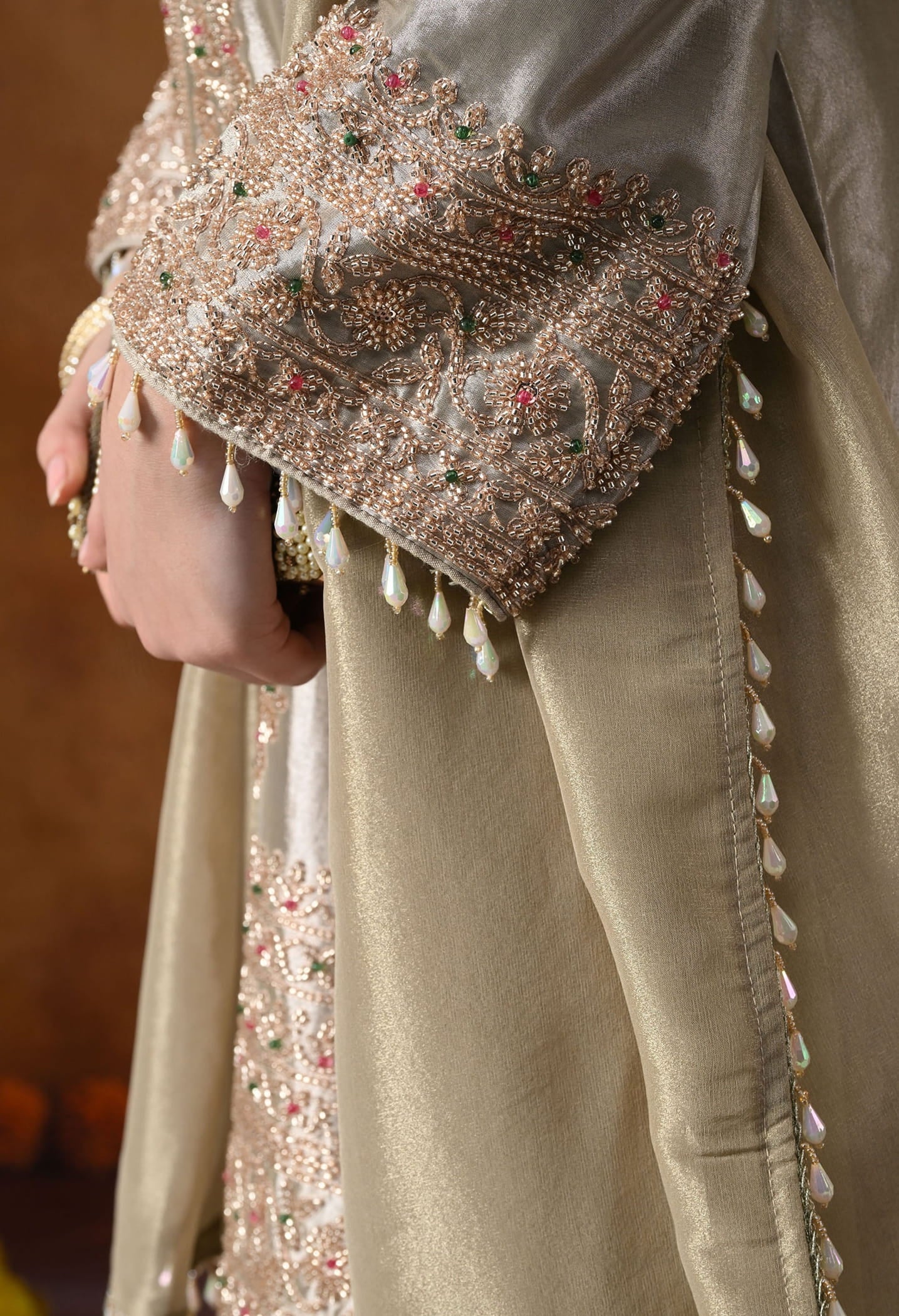 Golden Tissue Silk Kurta Set with intricate thread, pearl, and cutdana work, paired with a tissue organza dupatta and umbrella pants