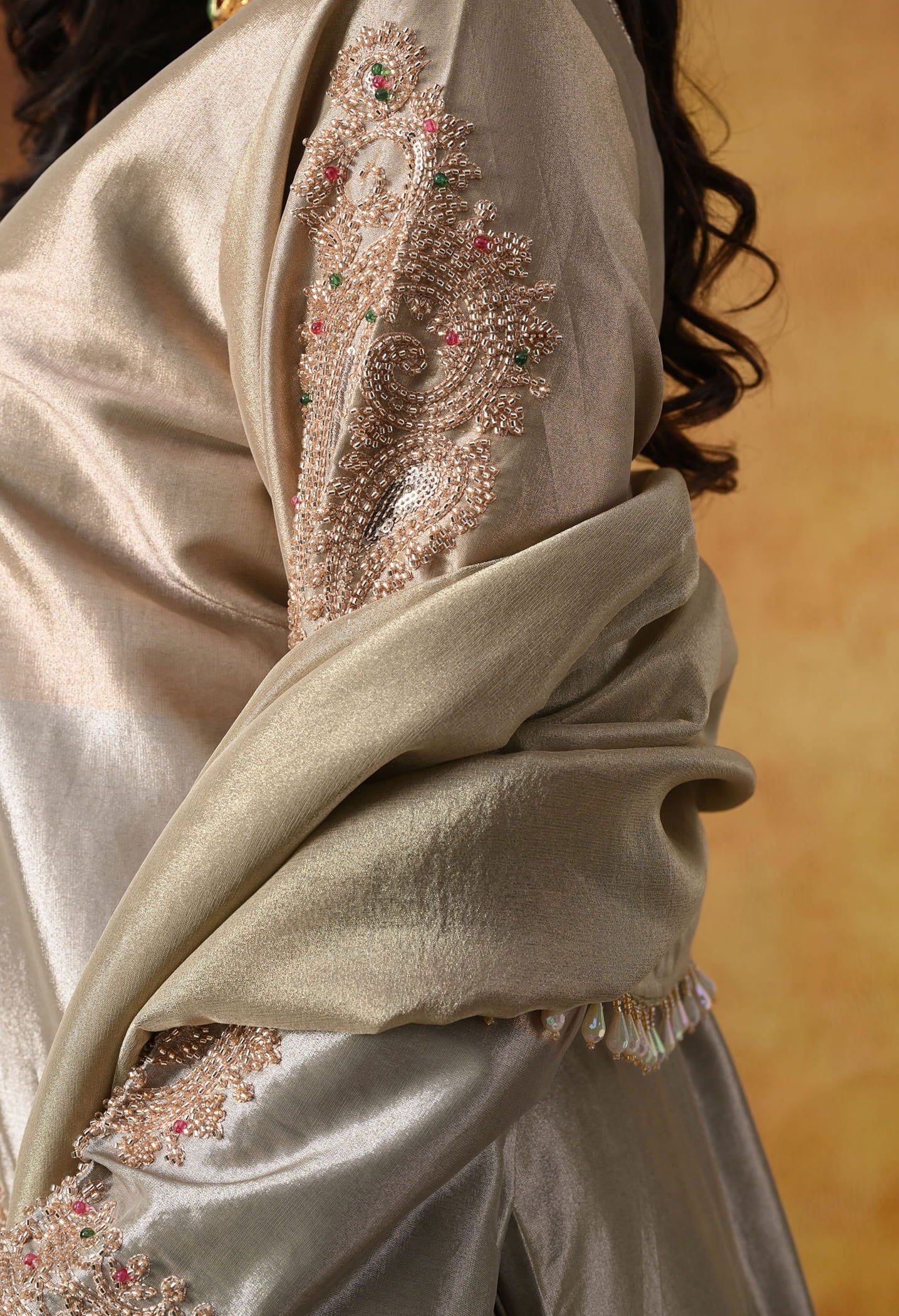 Golden Tissue Silk Kurta Set with intricate thread, pearl, and cutdana work, paired with a tissue organza dupatta and umbrella pants