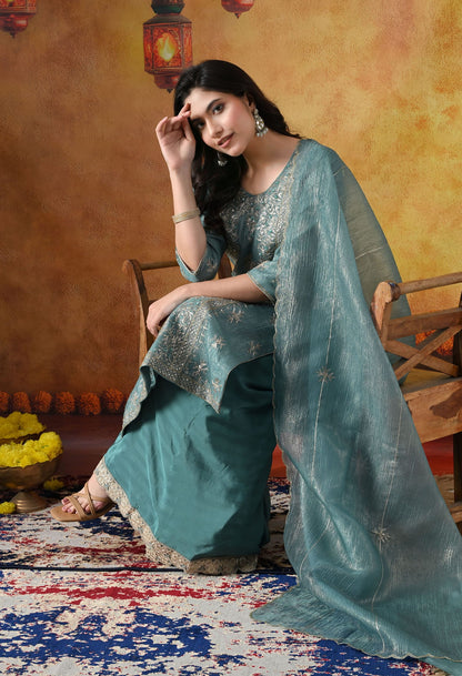 Turquoisesh Blue Sharara Set in crust tissue organza with intricate zardozi, dabka, sequin, and pearl work, paired with a crepe sharara