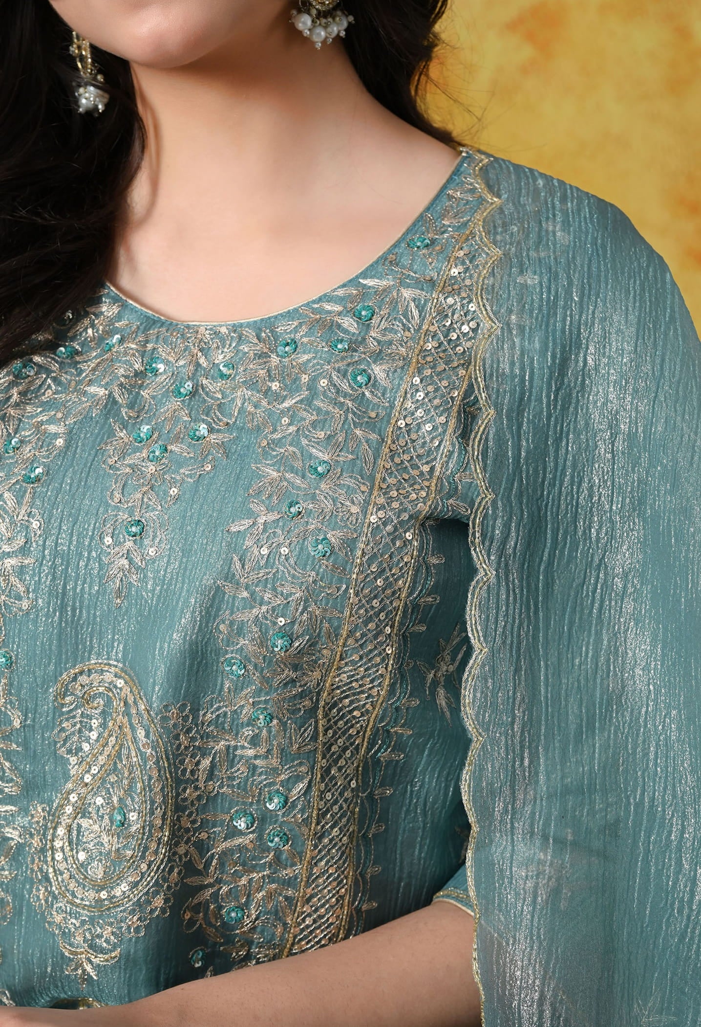 Turquoisesh Blue Sharara Set in crust tissue organza with intricate zardozi, dabka, sequin, and pearl work, paired with a crepe sharara