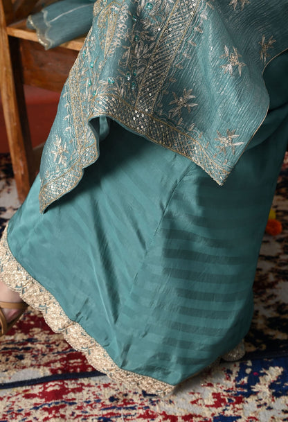Turquoisesh Blue Sharara Set in crust tissue organza with intricate zardozi, dabka, sequin, and pearl work, paired with a crepe sharara