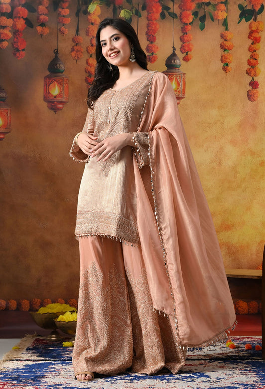 Peach Banarasi Silk Sharara Set with intricate thread, crystal, pearl, and cutdana work, paired with a tissue organza dupatta