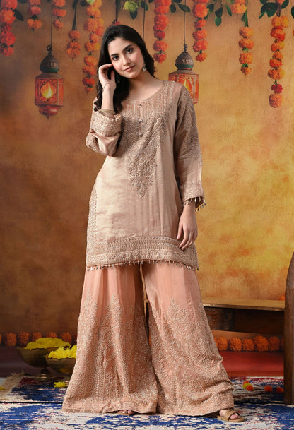 Peach Banarasi Silk Sharara Set with intricate thread, crystal, pearl, and cutdana work, paired with a tissue organza dupatta
