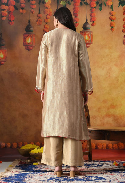 Golden Banarasi Silk Kurta Set with intricate zardozi, pearl, and dabka work, paired with a contrasting red organza dupatta and tissue silk palazzo
