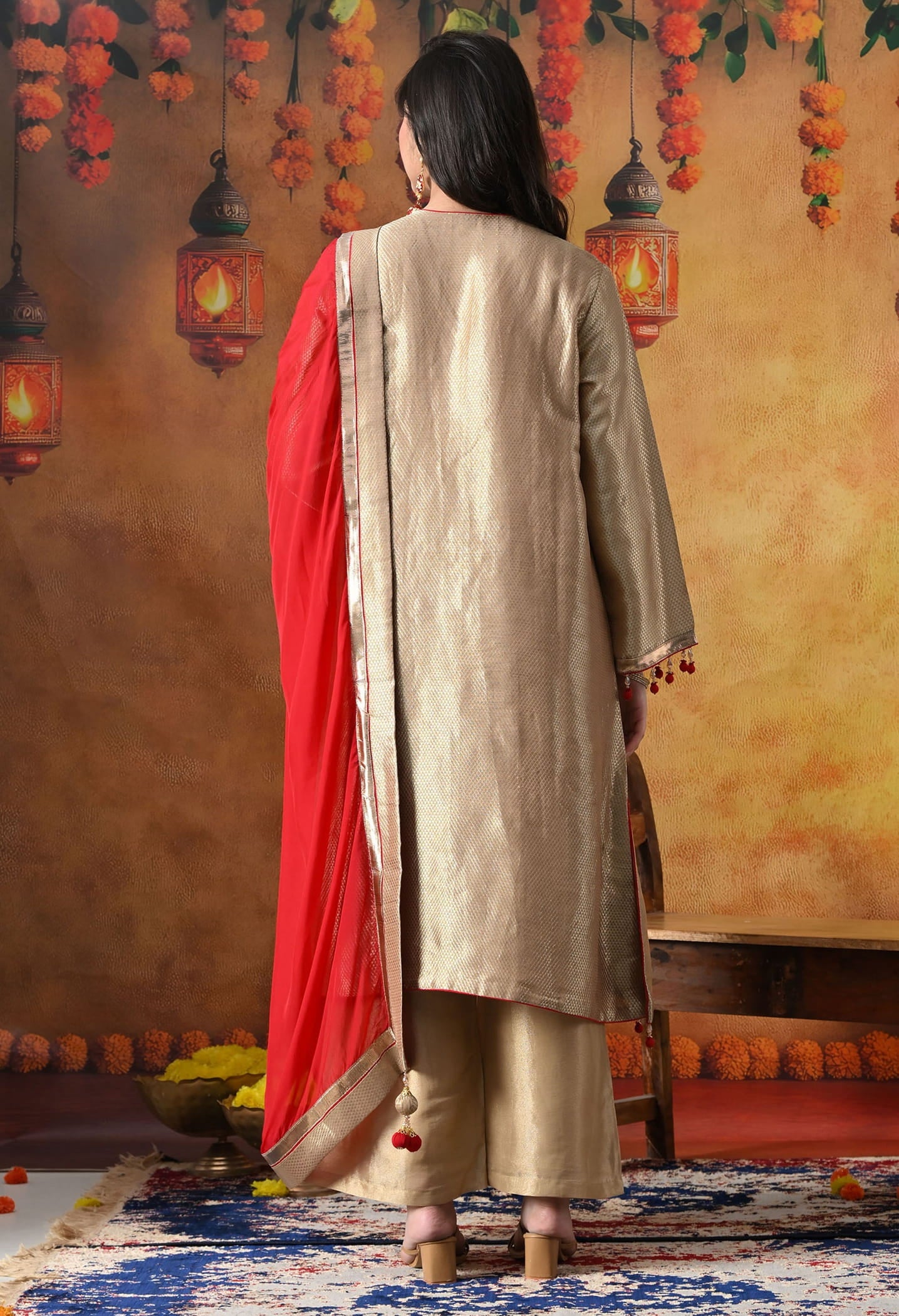 Golden Banarasi Silk Kurta Set with intricate zardozi, pearl, and dabka work, paired with a contrasting red organza dupatta and tissue silk palazzo