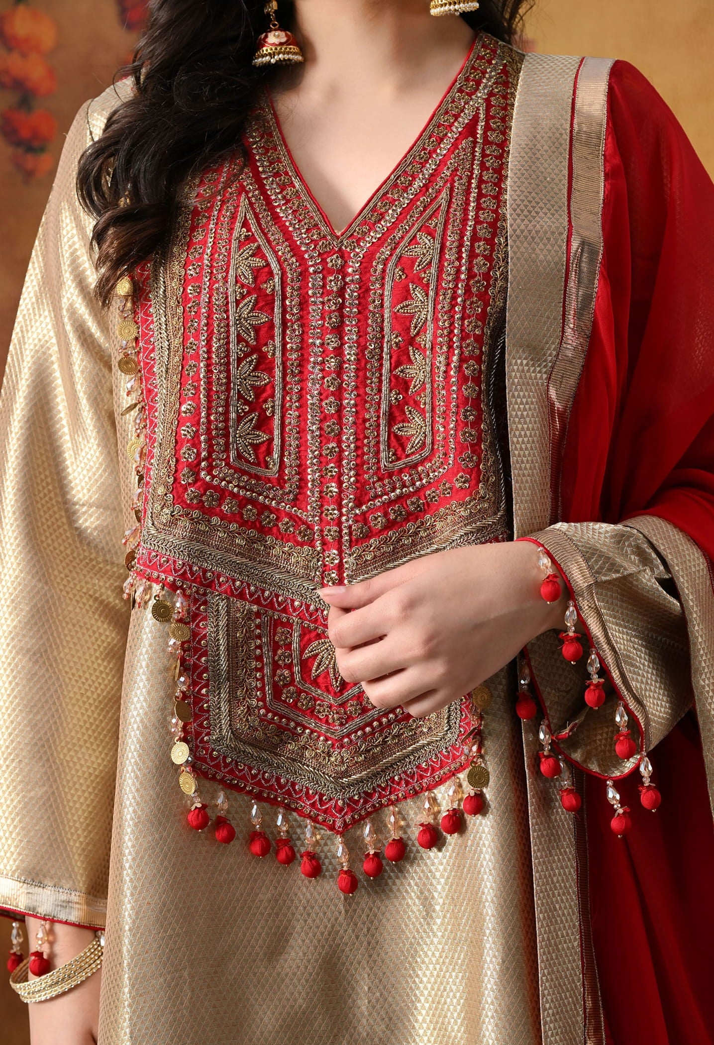 Golden Banarasi Silk Kurta Set with intricate zardozi, pearl, and dabka work, paired with a contrasting red organza dupatta and tissue silk palazzo